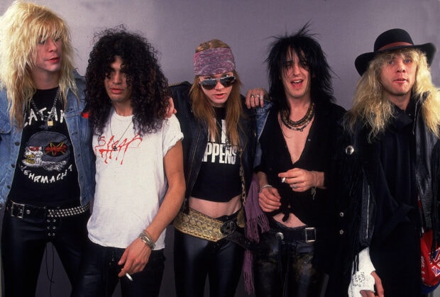 Guns N Roses band members posing together in stylish rock outfits