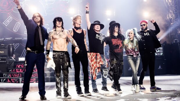Guns N Roses band members standing together on stage during a concert in high resolution