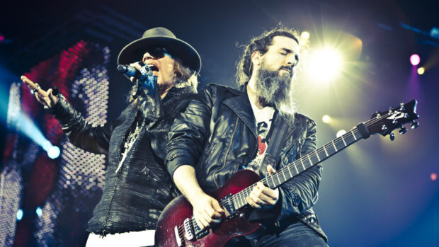 Guns N Roses guitarist playing electric guitar during live concert