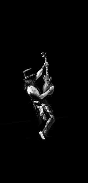 Guns N Roses guitarist playing on stage with a top hat and electric guitar