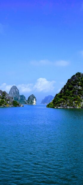 Calm sea with rocky islands and clear sky in Halong Bay landscape
