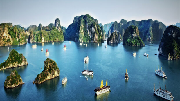 A scenic view of Halong Bay with lush limestone islands and traditional boats on the water