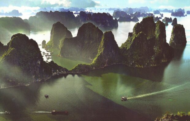 A breathtaking view of Halong Bay limestone formations surrounded by emerald green water