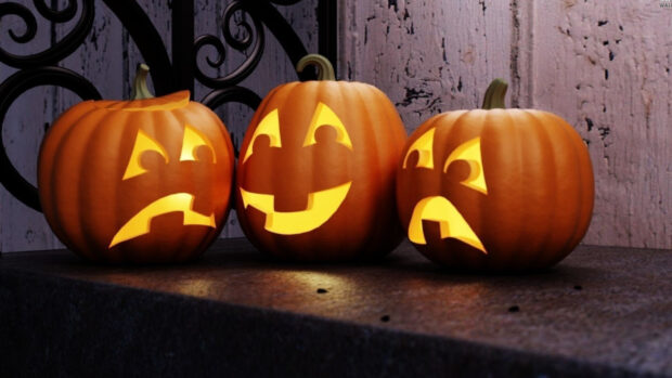 Three Halloween pumpkins with glowing carved faces on a dark surface, HD Desktop Wallpaper