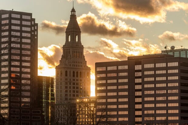 Historic Hartford skyline captured during sunset with glowing clouds and modern buildings