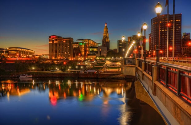 Evening cityscape of Hartford skyline reflecting on the river with vibrant lights and a clear sky