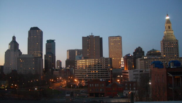 Hartford skyline at dusk with illuminated buildings and clear sky