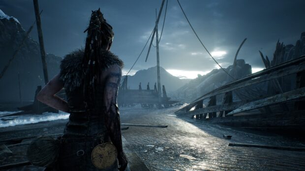 A Hellblade character looks out over a stormy beach with shipwrecks, 4K Desktop Wallpaper
