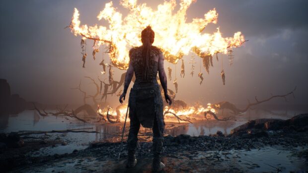 A warrior faces a massive burning tree with hanging figures in Hellblade wallpapers, 4K Desktop Wallpaper