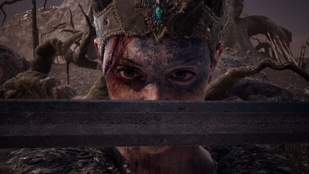 A close up of a warrior with tribal face paint holding a sword in front, 4K PC Wallpaper