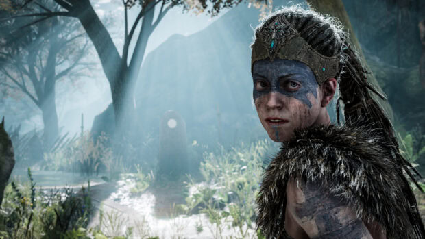 A Hellblade character with tribal paint stands in a sunlit forest clearing, 4K Desktop Wallpaper