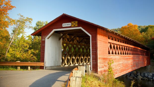 The Henry Bridge is surrounded by autumn trees in this Vermont Wallpapers scene, 2K Desktop Wallpaper