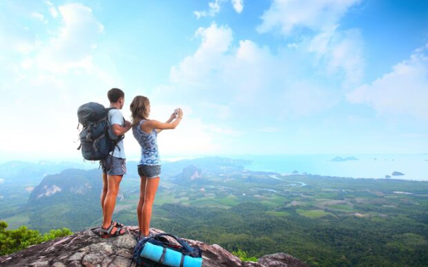 Two hikers enjoying a scenic mountain view during a hiking adventure