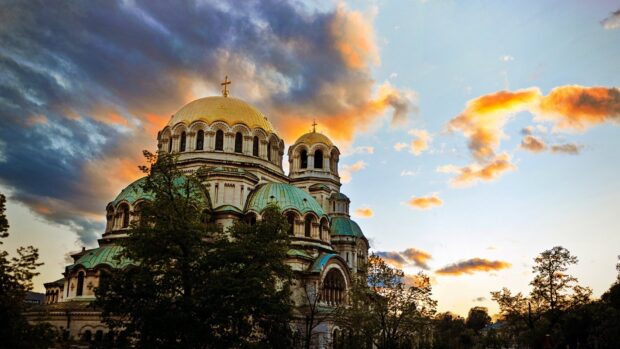 The Alexander Nevsky Cathedral stands under a vibrant sunset sky in Bulgaria, HD Desktop Wallpaper