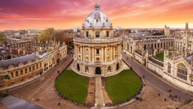 The historic architecture of Oxford University is shown during a sunset with vibrant sky, HD Desktop Wallpaper