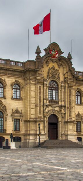 The historic building with the Peruvian flag in Lima Peru captures its colonial architecture, HD Mobile Wallpaper