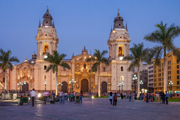 People walking in the square in front of historic architecture in Lima Peru, 2K Desktop Wallpaper