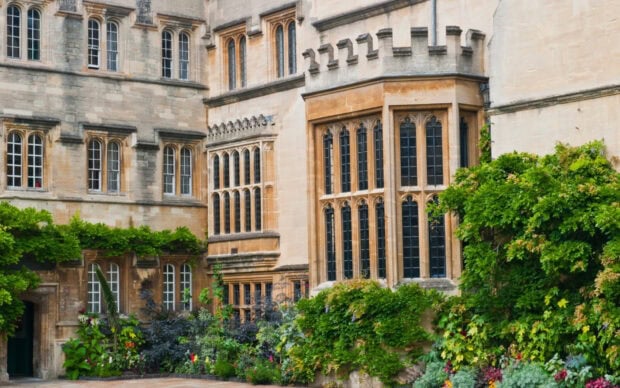 The image shows historic architecture and lush greenery at Oxford University, HD Desktop Wallpaper