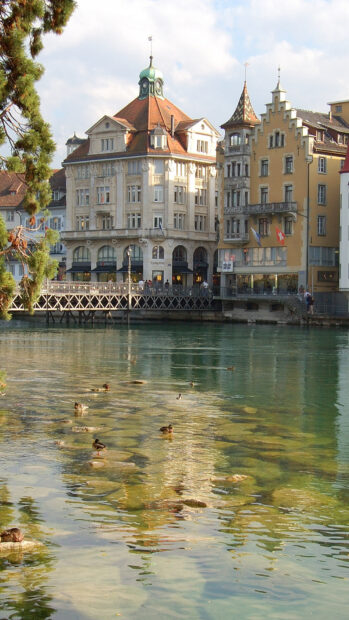 Historic buildings near a calm river reflecting in clear water under blue sky in Florence Wallpapers, HD Mobile Wallpaper