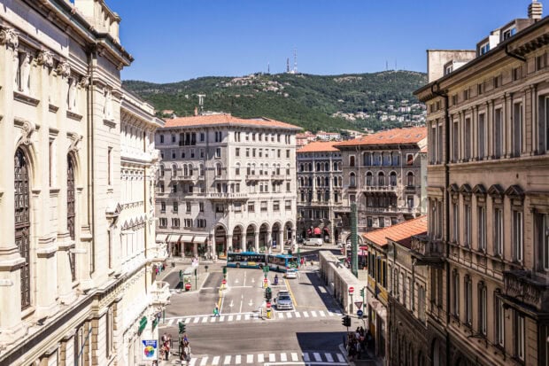 A bright day showing the historic architecture and busy streets in Trieste, Italy, 2K Desktop Wallpaper