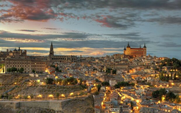 A stunning view of Spain cityscape with illuminated streets under a colorful sky, HD Desktop Wallpaper
