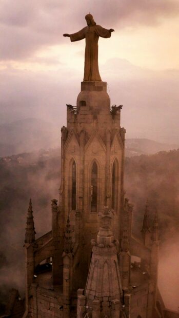 The statue overlooks misty mountains with Gothic architecture in Spain wallpapers, 2K Mobile Wallpaper