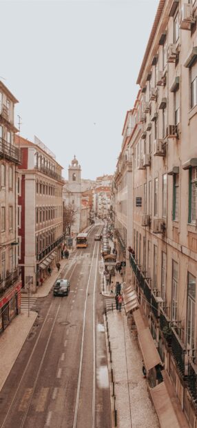 A busy street with trams and people in Lisbon Portugal Wallpapers, 2K Mobile Wallpaper