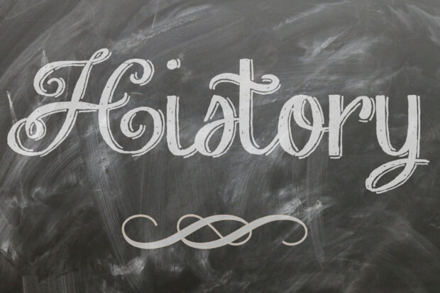 A chalkboard with decorative handwriting spelling out history on a blackboard surface