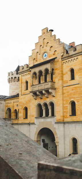 Historic castle architecture with sandstone facade and arched windows