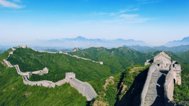 The Great Wall winding over green mountains showing history and ancient architecture