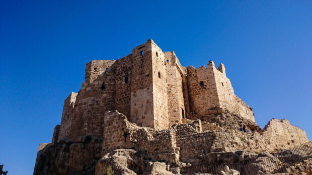 Ancient castle ruins showcasing history under clear blue sky