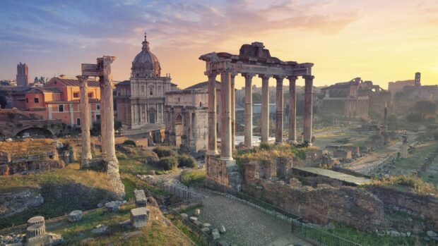 Ancient Roman ruins showcasing historical architecture and columns at sunset