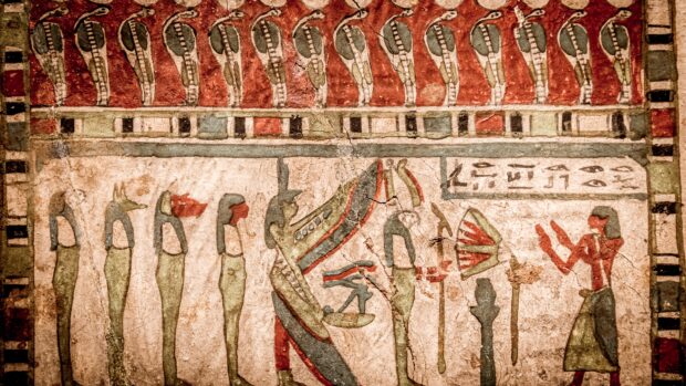 Ancient Egyptian hieroglyphic artwork showing mythological figures in a ceremonial scene