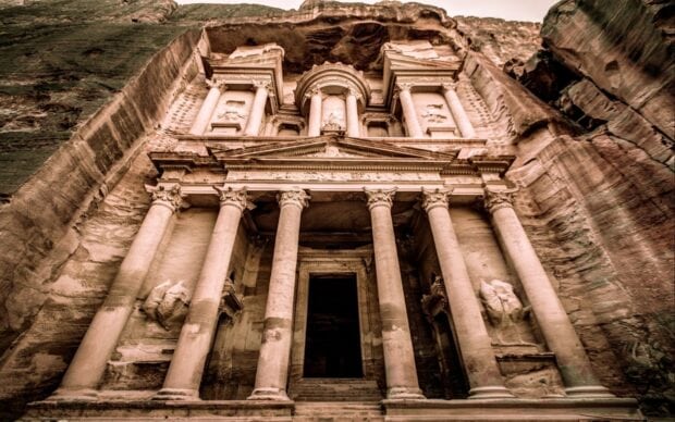 Ancient monument featuring classical columns carved into rock facade