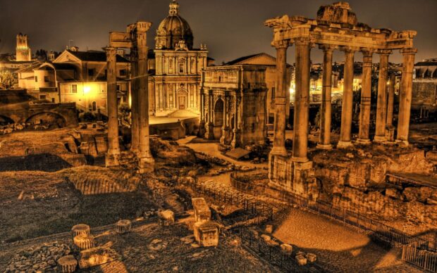 Ancient Roman ruins under golden light showcasing iconic columns and architecture from history