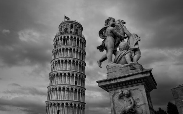 Leaning Tower of Pisa statue and cherubs sculpture under cloudy sky with history elements