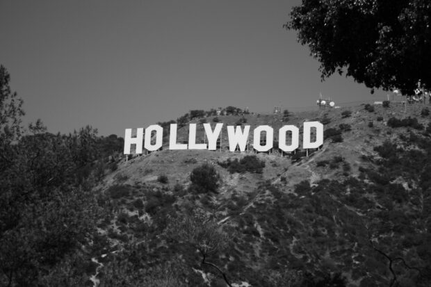 The iconic Hollywood sign on a hillside surrounded by trees and vegetation