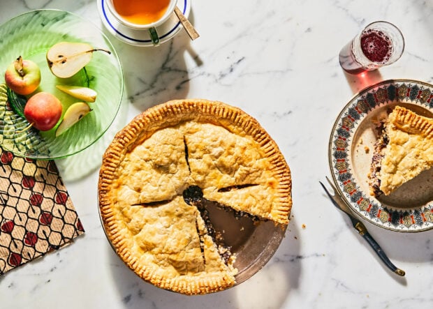 A homemade pie with sliced pieces sits on a table beside apples and a drink, 2K Desktop Wallpaper