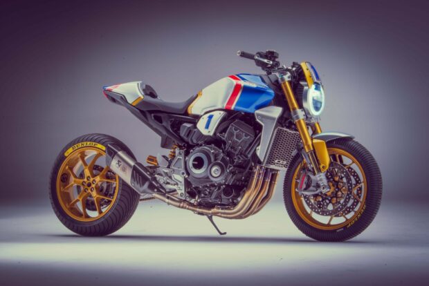 A Honda CB1000R motorcycle with classic design and golden accents in a studio setup, 2K Desktop Wallpaper