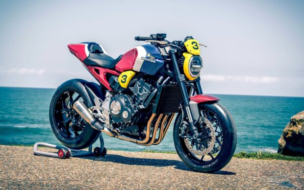 A Honda Cb1000R motorcycle is parked near the ocean on a sunny day, 2K Desktop Wallpaper