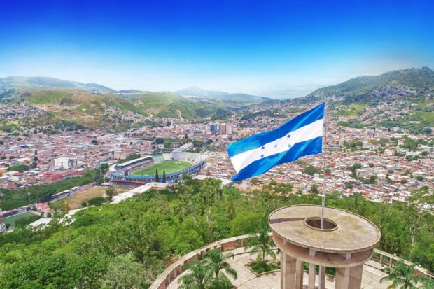 Scenic view of Honduras city with flag and stadium in vibrant landscape