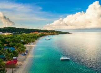 Tropical coastline in Honduras with clear turquoise water and lush green trees