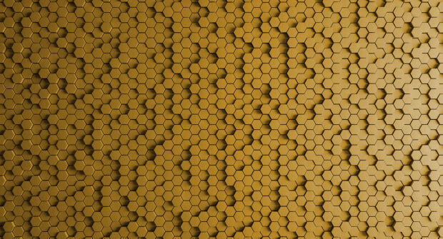 A honeycomb pattern with a radial ripple effect in golden tones, 2K Desktop Wallpaper