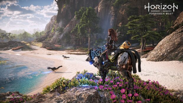 A Horizon Forbidden West character riding a robotic creature in a forested beach landscape