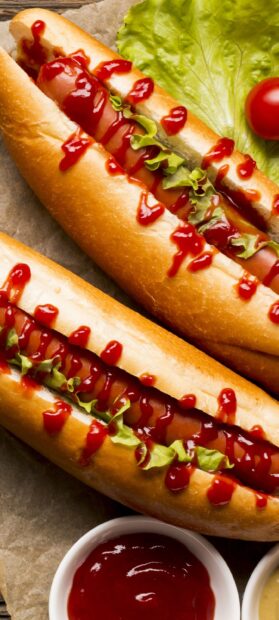 Close up of hot dog with ketchup and lettuce on a bun for hot dog