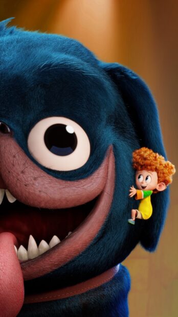 A boy climbing on the ear of a large blue creature from Hotel Transylvania