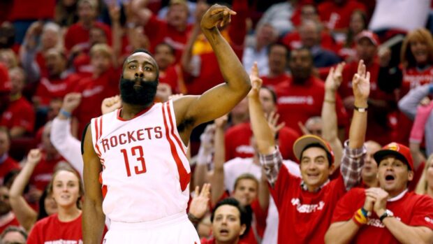 Houston Rockets player celebrating a basketball game in front of cheering fans
