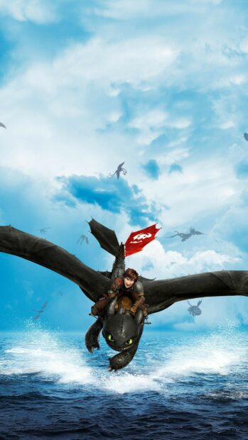 A young Viking riding a dragon over the ocean in a How To Train Your Dragon scene