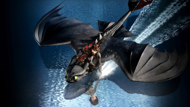 A young warrior riding a dragon flying over water in How To Train Your Dragon