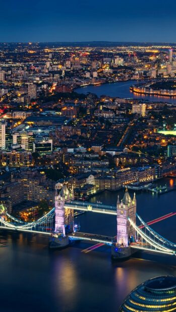The United Kingdom shows the Tower Bridge lit up at night with the river and city lights around it in the United Kingdom, HD Mobile Wallpaper